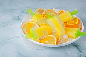 Fruit orange ice lolly and slices of orange