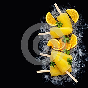 Fruit orange ice lolly and slices of orange.Top view. Copy space