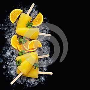 Fruit orange ice lolly and slices of orange.Top view. Copy space