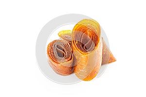 Fruit pastille from apples and apricots, dried leaves of mashed fruit and berries. Organic food. Natural products. Isolated