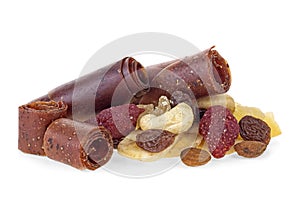 Fruit pastille and heap of dried fruits, seeds and nuts. White background.