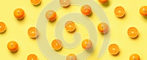 Fruit pattern of fresh orange slices on yellow background. Top view. Copy Space. Pop art design, creative summer concept. Half of