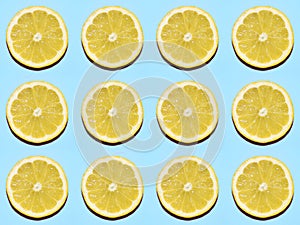 Fruit pattern. Slices of lemon on blue background