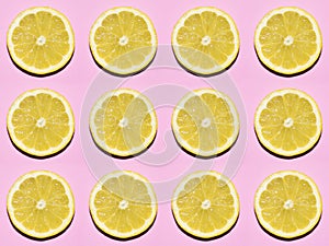 Fruit pattern. Slices of lemon on pink background