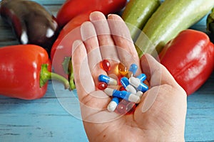 Fruit and pills, vitamin supplements with on wooden background. Healthy lifestyle, diet concept