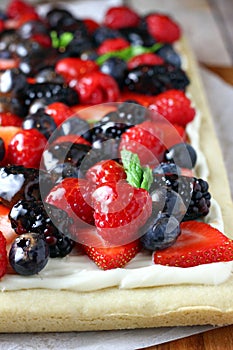 Fruit pizza with blackcurrants and strawberries