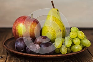 Fruit plate grapes apple plum pear