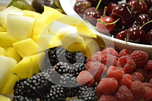 Fruit platter with blackberries, honeydew melons, cherries and mango