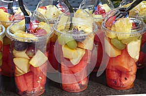 Fruit pots with lids and fork close-up