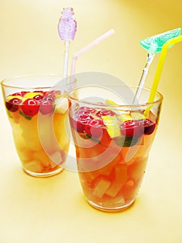 Fruit punch cocktail drinks with cherry