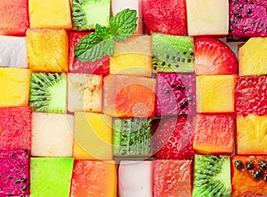 Fruit puzzle. Colorful food background or pattern arranged of different fruit cubes. Dietary concept