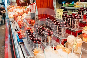 Fruit Salad arranged in plastic cups on a market stall with small fork inside, takeaway snack