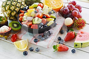 Fruit salad bowl fresh summer fruits and vegetables healthy organic food watermelon strawberries orange kiwi blueberries dragon