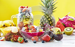 Fruit salad fresh summer fruits and vegetables healthy organic food strawberries orange kiwi blueberries dragon fruit tropical