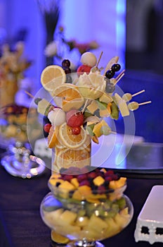 Fruit salad in glass ready cups. Pieces of organic fruits and berries, healthy snack