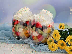 Fruit salad in glasses with cream. photo