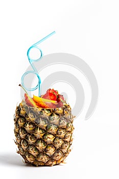 Fruit salad and juice in a pineapple shell isolated