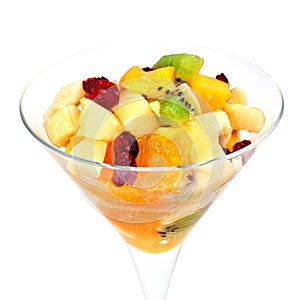 Fruit salad in a martini glass isolated on white