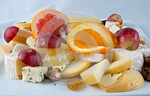 Fruit salad with nuts, raisins and cheese.