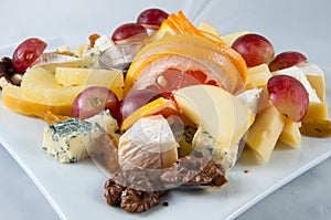 Fruit salad with nuts, raisins and cheese.