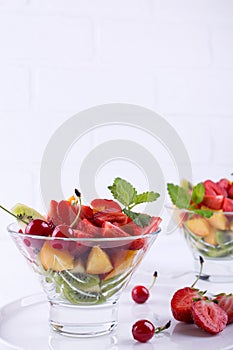 Fruit salad of strawberries, kiwis and apricots. tasty snack