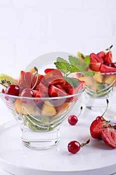 Fruit salad of strawberries, kiwis and apricots. tasty snack