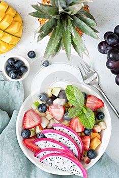 Fruit salad with tropical fruits in a bowl