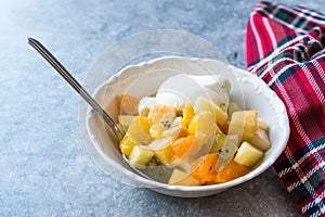 Fruit Salad with Vanilla Ice Cream in Ceramic Bowl