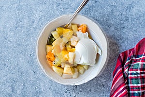 Fruit Salad with Vanilla Ice Cream in Ceramic Bowl