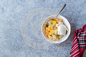 Fruit Salad with Vanilla Ice Cream in Ceramic Bowl