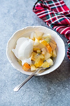 Fruit Salad with Vanilla Ice Cream in Ceramic Bowl