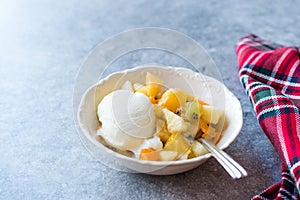 Fruit Salad with Vanilla Ice Cream in Ceramic Bowl