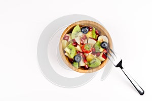 Fruit Salad in Wooden Bowl with a Fork on White Table, Top View