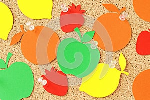 Fruit shaped paper note on pinboard