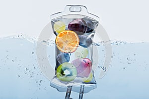 Fruit Slices In Saline Bag Dipped In Water Against Background