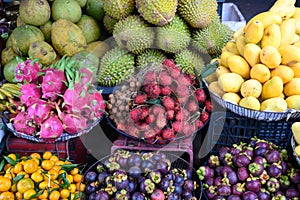 Fruit stable with ripe fruits, water chestnut, mangos, mandarins, dragon fruits, jack fruits, lychees in Hoi An, Vietnam, Asia