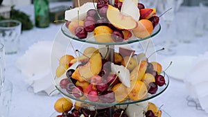 Fruit on a stand panorama, peaches, cherry.