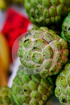 Fruit sugar apple on the counter of the fruit market. Fruits sugar-apple the size of a large apple, green, knobby.