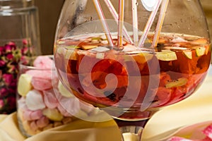 Fruit sungria party big glass, lots of straws on table