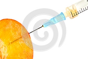 Fruit with syringe inserted