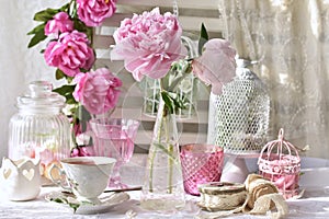 Fruit tea in beautiful porcelain cup and peony flowers