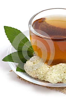 Fruit tea in cup with mulberry