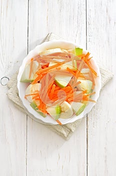 Fruit vegetable salad with carrots, apples, bananas, top view