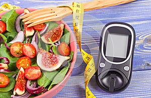 Fruit and vegetable salad, glucose meter for measurement sugar level and tape measure, concept of diabetes