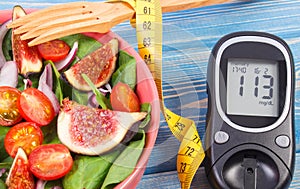 Fruit and vegetable salad and glucose meter with tape measure, diabetes, slimming and healthy nutrition concept