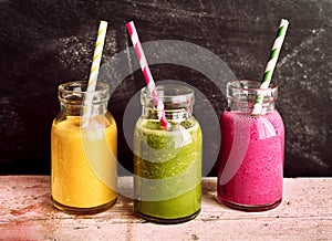 Fruit and Vegetable Smoothies in Jars with Straws photo
