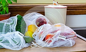 Fruit and Vegetables in reusable mesh bags, with reuse me labels, on kitchen counter