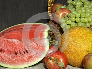 Fruit. Watermelon, melon, grapes and apples on the table