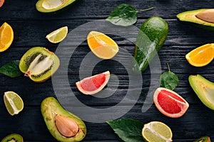 Fruit on a wooden background. Avocado, lime, orange, grapefruit and kiwi. Top view.