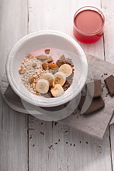 Fruit yogurt with different toppings on the white wooden table vertical